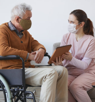 an adult woman showing soemthing to an elderly man